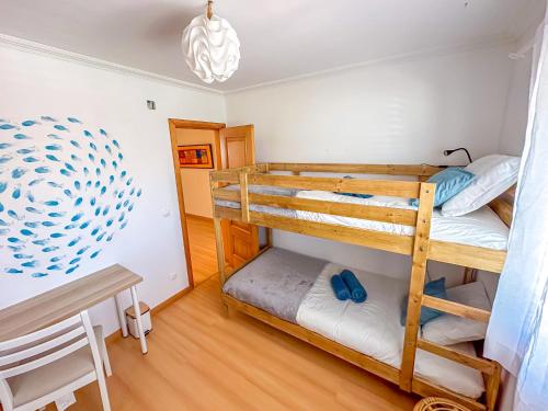 a bedroom with two bunk beds in a room at Baleal Bay Guesthouse in Baleal