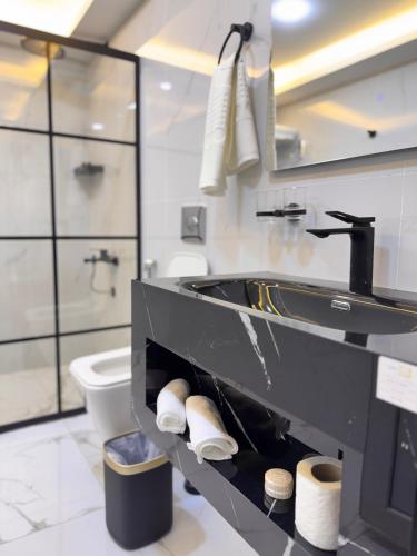 a bathroom with a sink and a toilet at Wadi Rum Lana luxury camp in Wadi Rum