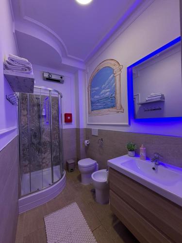 a bathroom with a shower and a toilet and a sink at Beach house airport in Fiumicino