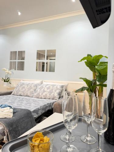 a living room with wine glasses on a table at Beach house airport in Fiumicino