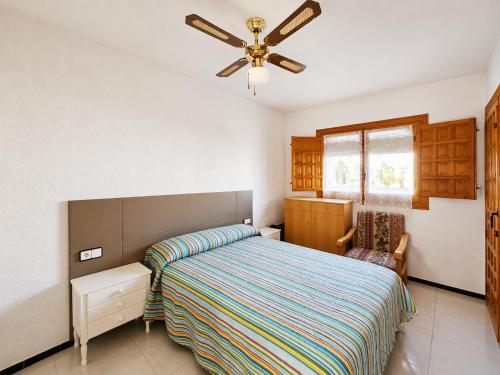 a bedroom with a bed and a ceiling fan at Stay in Costa Hispania in Santa Pola