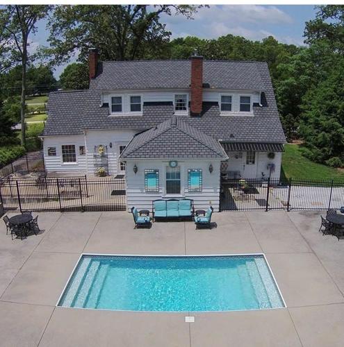 a house with a swimming pool in front of a house at Swamp Rabbit Inn TR in Travelers Rest