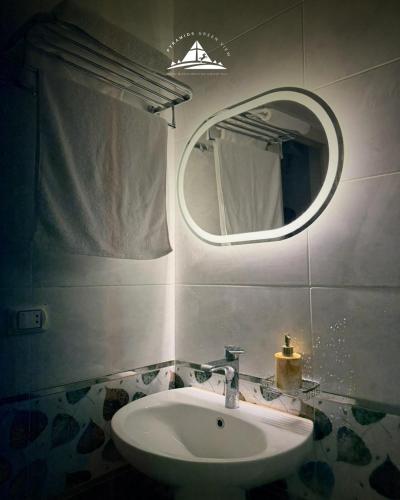 a bathroom with a sink and a mirror at Pyramids Green View in Cairo