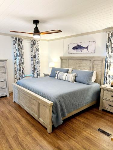 a bedroom with a bed and a ceiling fan at Charming Lake Front Home and Pavilion in Milledgeville