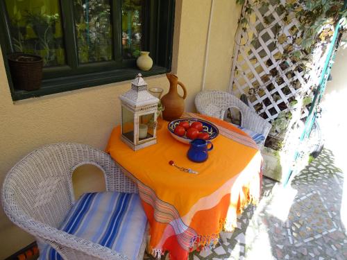 an orange table with a bowl of tomatoes on it at Apartament - Lisa in Budva
