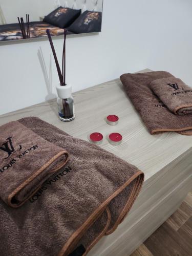 a table with two brown towels on top of it at La Terrazza di Rovaglioso in Palmi
