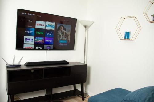 a flat screen tv on a wall in a bedroom at True North - A Beach & Boat Lover's Dream in Carolina Beach