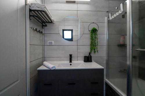 a bathroom with a sink and a mirror at צימר אדל - Zimmer Adel in Yavneʼel