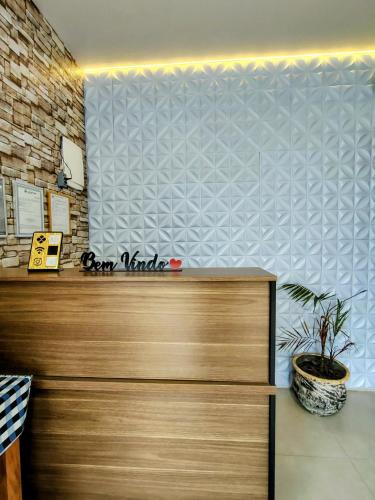 a reception desk in a room with a wall at Chalés e suítes lima in Monte Verde