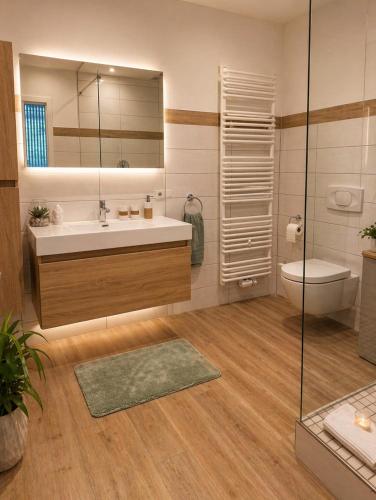 a bathroom with a sink and a toilet and a mirror at Premium Lodge nahe Cochem - 5-Sterne- Ferienwohnung - 149 qm - für 2-6 Gäste in Greimersburg