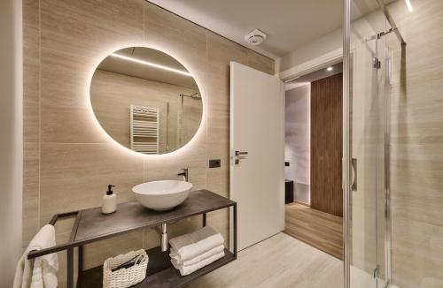 a bathroom with a sink and a mirror at Monolocale 1 - via Sassi, Lecco in Lecco