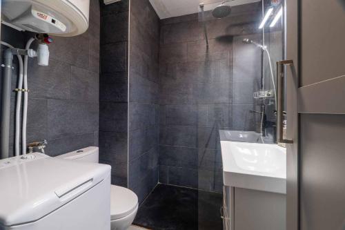 a bathroom with a toilet and a sink and a shower at Charmant studio climatisé à deux pas de la plage! in Anglet