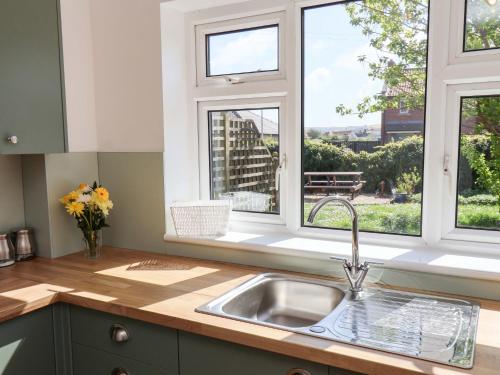 a kitchen with a sink and a window at Seashells at Runswick Lodge in Saltburn-by-the-Sea
