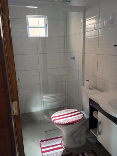 a bathroom with a shower with a toilet and a sink at Casa in Rosário do Sul