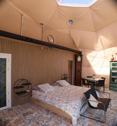 a bedroom with a large bed in a tent at Nuit Insolite dôme Reinette tout confort in Châtenois