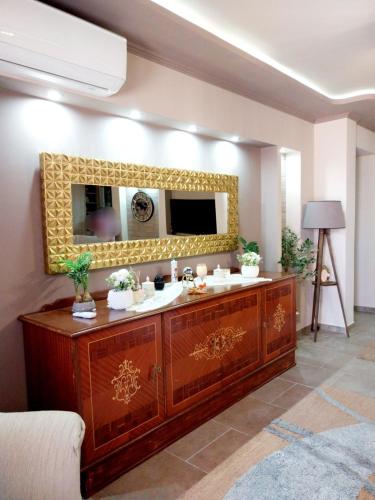 a bathroom with a sink and a mirror at Speranza's Sweet Home, Family House with Garden in Vrontantos in Vrontádos