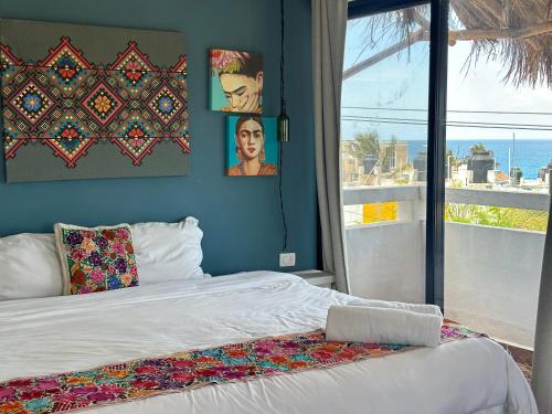 a bedroom with a bed with a laptop on it at Kay Apartments Isla Mujeres in Isla Mujeres