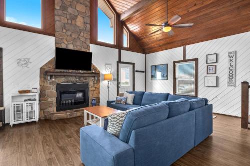 a living room with a blue couch and a fireplace at Salty Dawg by Oak Island Accommodations in Oak Island