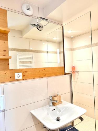 a bathroom with a sink and a mirror at Sunny Alpine Apartment - 180 View in Lens