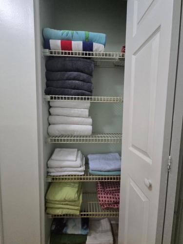a closet with a bunch of towels and towels at Your Space Coast Home - 30 Seconds to Sand in Cape Canaveral