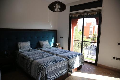 a bedroom with a bed and a large window at villa Marrakech 3chambre in Marrakesh