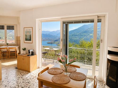 a living room with a table and a view at Casa Lagò Lagò Panoramic Apartment in Ranzanico