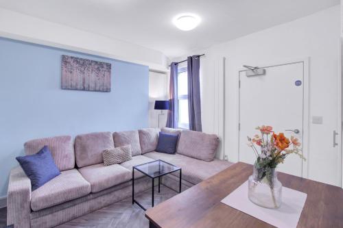 a living room with a couch and a table at Spacious Central Home, Garden & Parking in Gloucester