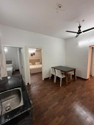 a kitchen and dining room with a table and a sink at Sunshine Park By RoomzAway in Candolim