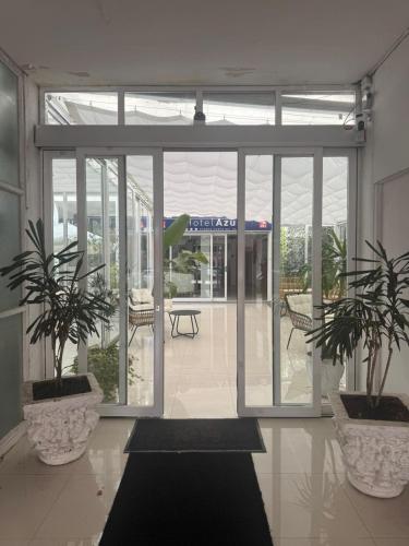 a lobby with two potted plants in a building at Hotel Azul by MH in Punta del Este