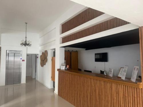 a lobby with a reception desk and a flat screen tv at Hotel Azul by MH in Punta del Este