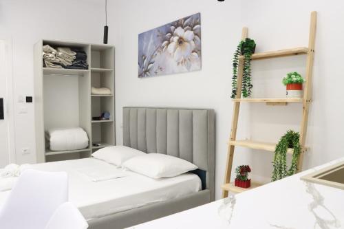 a bedroom with two beds and a shelf at Aura boutique hotel in Vlorë