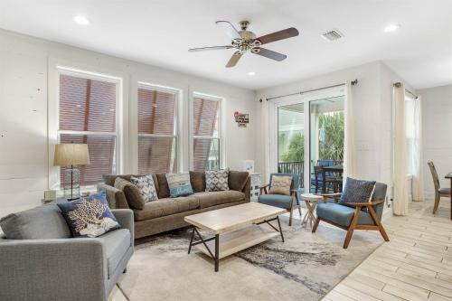a living room with a couch and a table at PRIME True Blue Walk to Beach Pool Pets Near The Hangout Parking in Gulf Shores