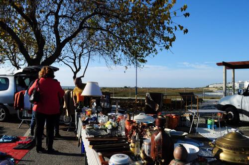 a woman standing in front of a flea market at Casa da Avó Nina in Fuzeta