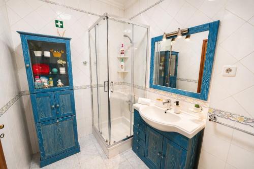a bathroom with a blue cabinet and a sink at Nova Onda - Cozy 2BR Apartment with Private Terrace in Nazaré