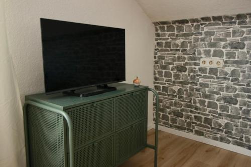 a flat screen tv sitting on top of a dresser at Helle Ferienwohnung im Schwarzwald - 2 Schlafzimmer - WLAN - Holzapfel Apartments in Villingen-Schwenningen