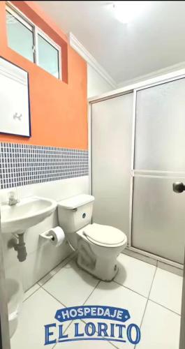 a bathroom with a toilet and a sink and a shower at Hospedaje El Lorito in Barranquilla