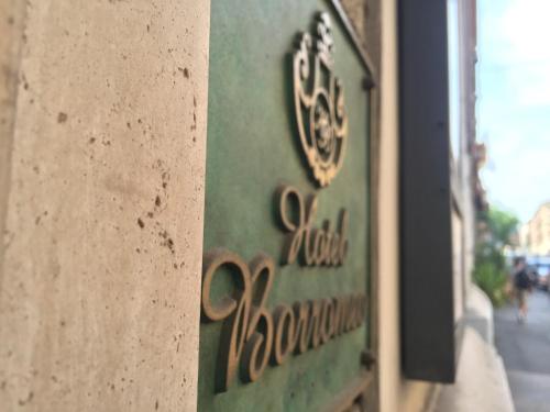 a sign on the side of a building at Hotel Borromeo in Rome