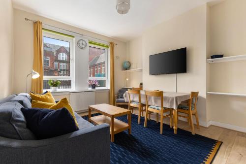 a living room with a couch and a table at Hotspur House in Glasgow