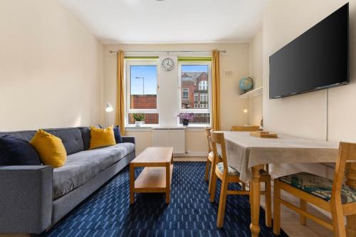 a living room with a couch and a table at Hotspur House in Glasgow