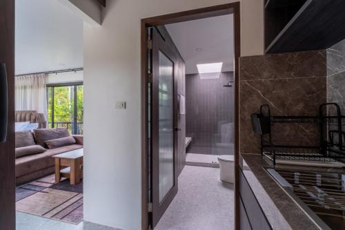 a kitchen with a glass door leading to a living room at Aranya Bliss Villa 104 in Wok Tum