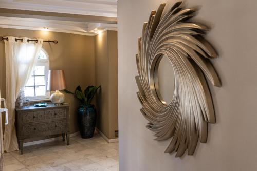 a mirror hanging on a wall in a room at Villa Moments - Guest House in Portimão