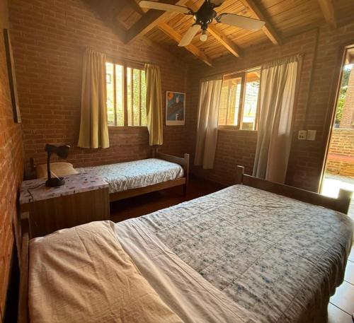 a bedroom with two beds and a ceiling fan at Casa La Selva in Ostende