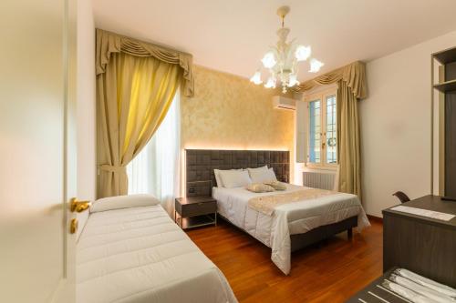 a bedroom with a bed and a large window at Villa Bellini Room&Breakfast in Porto Garibaldi