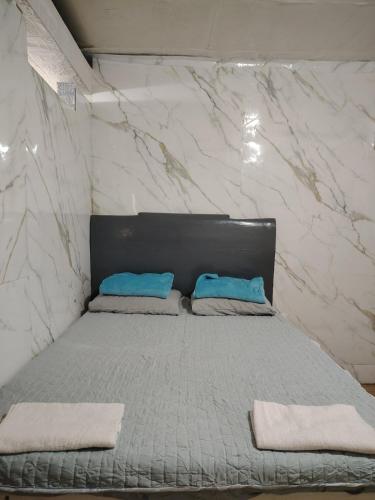 a bed with two pillows on it in a room at PrincessStar in Pagadian