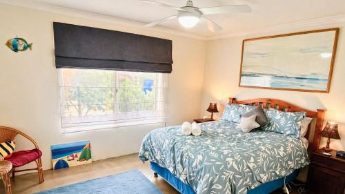 a bedroom with a bed and a window at The Orchid Courthouse - Busselton in Geographe
