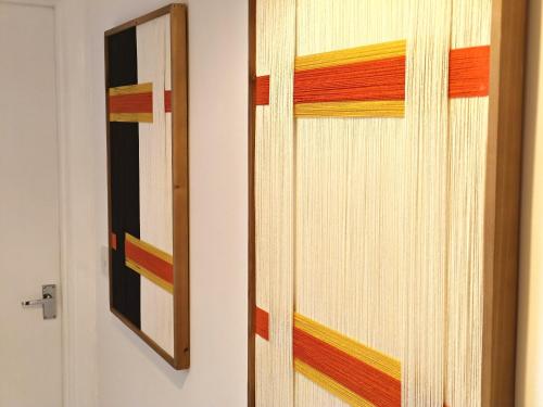 a wooden door with a mirror on a wall at Sea Breeze in Bournemouth