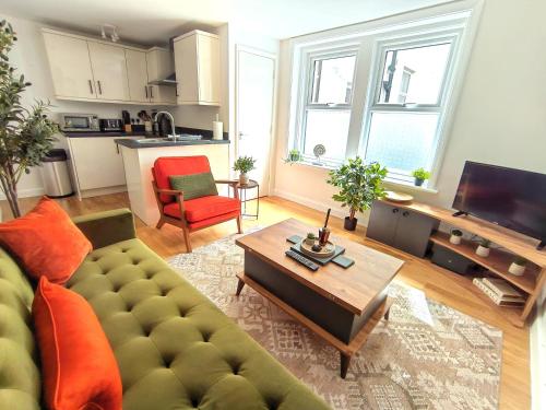 a living room with a couch and a table at Sea Breeze in Bournemouth