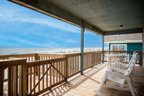 a deck with two chairs and the beach at Blue Haven by Oak Island Accommodations in Oak Island