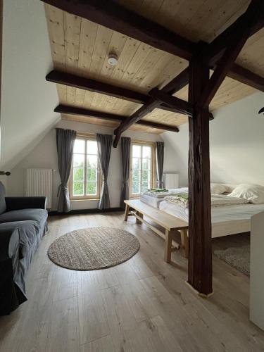 a large room with a bed and a table at Vierseithof "Waitzdorfer Hof" in Hohnstein