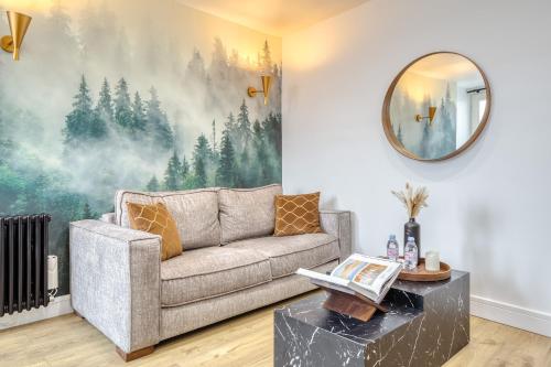 a living room with a couch and a mirror at Paris Central Gem 9 Min Walk to Notre-Dame and Louvre in Paris